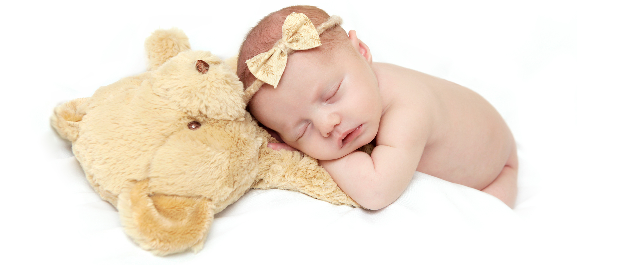 baby asleep with teddy bear toy photoshoot. at home